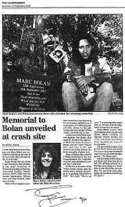 SCAN OF THE OBSERVER NEWSPAPER ARTICLE DATED 14TH SEPTEMBER 2002 SHOWING ROLAN BOLAN WITH THE BRONZE BUST HE UNVEILED AT THE MARC BOLAN MEMORIAL GARDENS, BARNES, LONDON CREATED BY QUEBEC SCULPTOR JEAN ROBILLARD